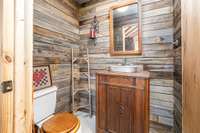 1/2 Bath located off the Kitchen w/ barn wood accent walls