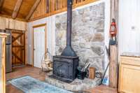 Wood burning Stove for the crisp cool nights with stone wall accent