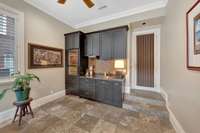 The craft room includes a wet bar with a copper sink and 30" dual zone Sub Zero wine cooler and two refrigerator drawers.