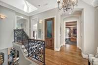 The upstairs landing has skylights, a custom wrought iron railing along with oak floors and 9' to 14" ceilings.