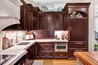 The kitchen includes 36" Sub Zero refrigerator with separate freezer drawers, stunning granite countertops and a Uline pellet ice maker.