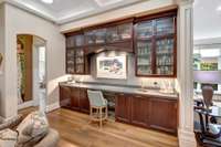 The recently updated wet bar includes fluted glass doors, and a bar refrigerator, with abundant storage and an optional work space.