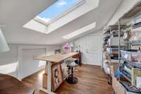 The wrapping room has Velux skylights and access to second floor attic storage complete with sun tunnel lighting.