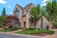 The exterior features handmade bricks, real stucco and limestone arches.