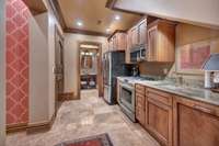 The in-law suite kitchen has a GE Cafe 6 burner gas stove with a convection oven, GE Cafe microwave, and a Maytag french door refrigerator with bottom freezer and ice/water.