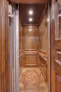 The stunning elevator with inlaid floor services all three floors.