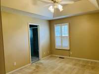 Owner's Bedroom with tray ceiling, full bath and walk in closet