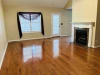 Living Room with beautiful hardwood floors and a gas log fireplace