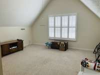 Bonus Room over the garage has a 1/2 bath and access to attic storage