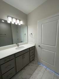 Master bath with tile floor and extended quartz counter