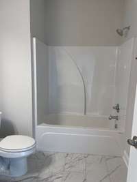 Hall bath with tile floor and quartz counters