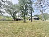 5 acres with two duplexes (2685 Lick Creek on left & 2669 Lick Creek on the right)