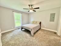 Master bedroom with attached full bathroom and walk-in closet