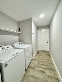 Laundry room with exterior door to side door