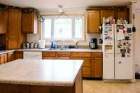 Kitchen with lots of counters, cabinets and island.