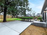 Brand new concrete driveway and stoop.  Freshly graded backyard with new grass.