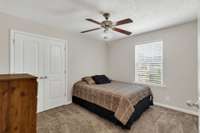 Bedroom 2 features a ceiling fan/light fixture, oversized closet and fresh wall and trim paint which is throughout the entire home.