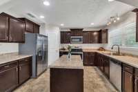 Large kitchen with plenty of cabinets and countertop space ready for a chef cooking at any level.  Corner Pantry for even more space