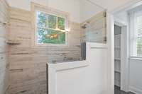 Stylish walk-in shower with glass enclosure and stylish tile, adding character and spa-like comfort to the space.