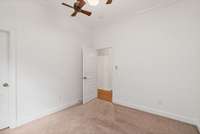 Bedroom two of three: Another angle highlights the room’s clean lines, natural light, and convenient closet and hallway access.
