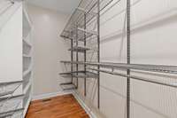Custom walk-in closet with a full metal shelving system, and hanging space for efficient and flexible storage.