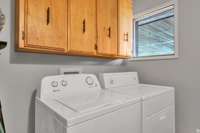 utility room has a pantry and extra shelving
