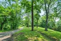 more than a half mile private drive meanders up the hill to the house ,offering peace, privacy and natural beauty
