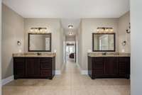The primary bath suite is well appointed with his & her separate vanities, tile flooring as well as his & her walk-in closets.