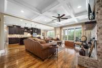 The living room is well appointed with a coffered ceiling, recessed lighting and triple windows for tons of natural light.