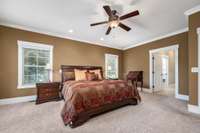 His & her reading lights, ceiling fan, crown molding and tons of natural light.