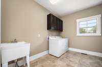 And there's a wash sink and tile floors.