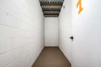 Storm shelter in basement - 14x5, solid core concrete walls, steel & concrete ceiling with steel door, 8 ft underground.