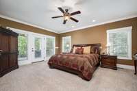 The primary bedroom with walk out access to the covered back porch and incredible views.