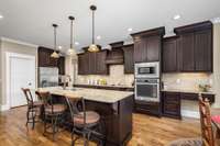 The kitchen greets you with ceiling height cabinets, built-in oven & microwave as well as a spacious pantry.