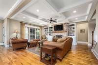 The living room features built-in bookcases & storage cabinets flanking an all brick fireplace as well as sand & finish hardwood floors.