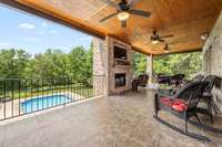 Covered, tiled porch with wood burning fireplace, triple ceiling fans and views for days!