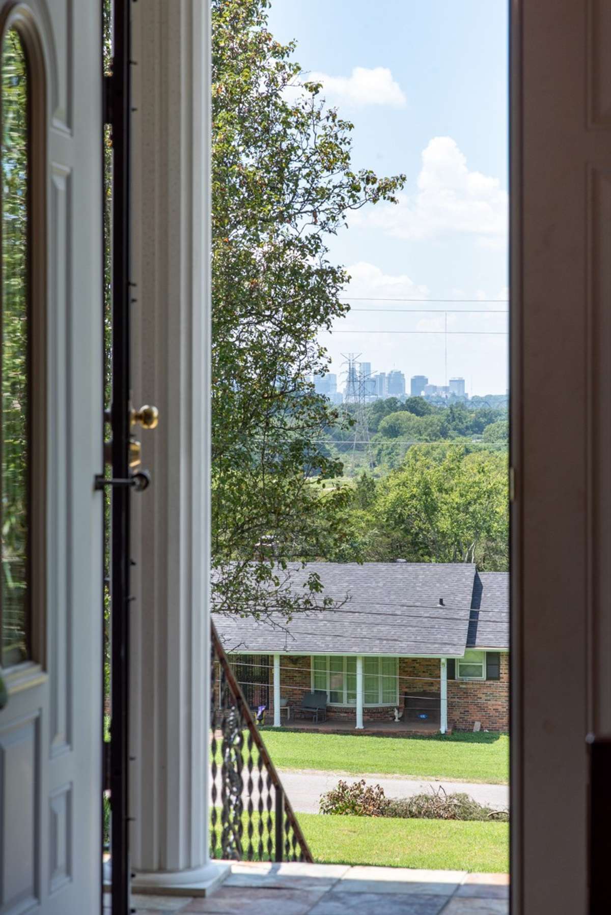 Welcoming entry with elegant double doors—open them to enjoy a stunning view of the Nashville skyline right from your foyer.