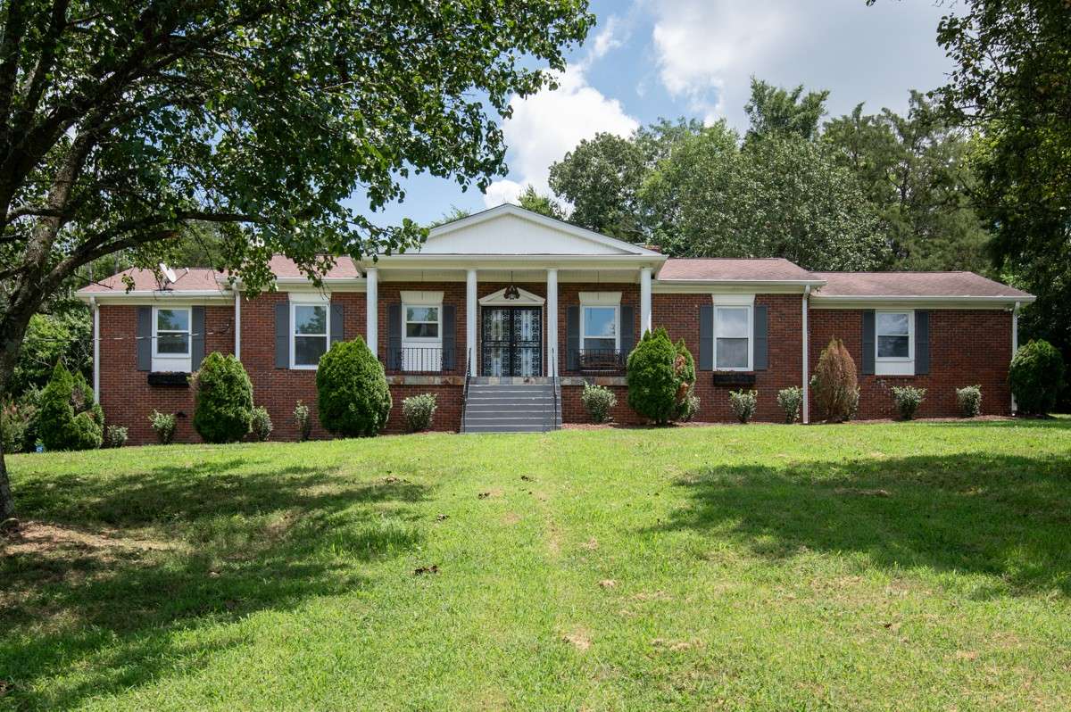 Beautiful brick home on a spacious, private lot with lush landscaping and an inviting backyard pool—perfect for relaxing or entertaining.