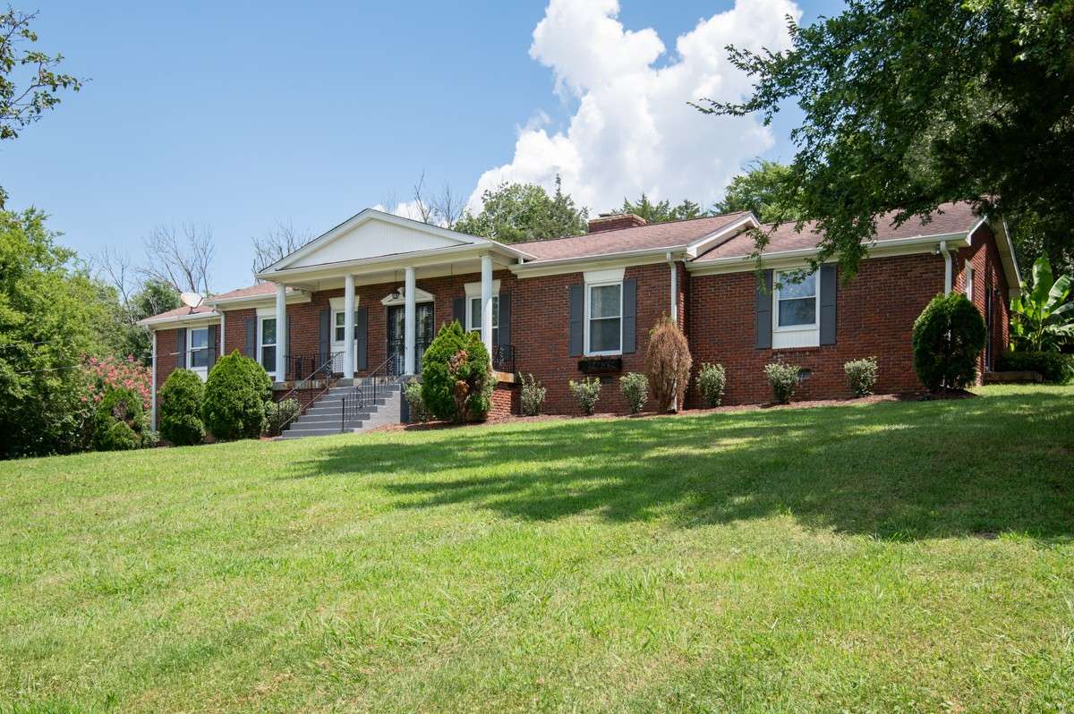 Beautiful brick home on a spacious, private lot with lush landscaping and an inviting backyard pool—perfect for relaxing or entertaining.