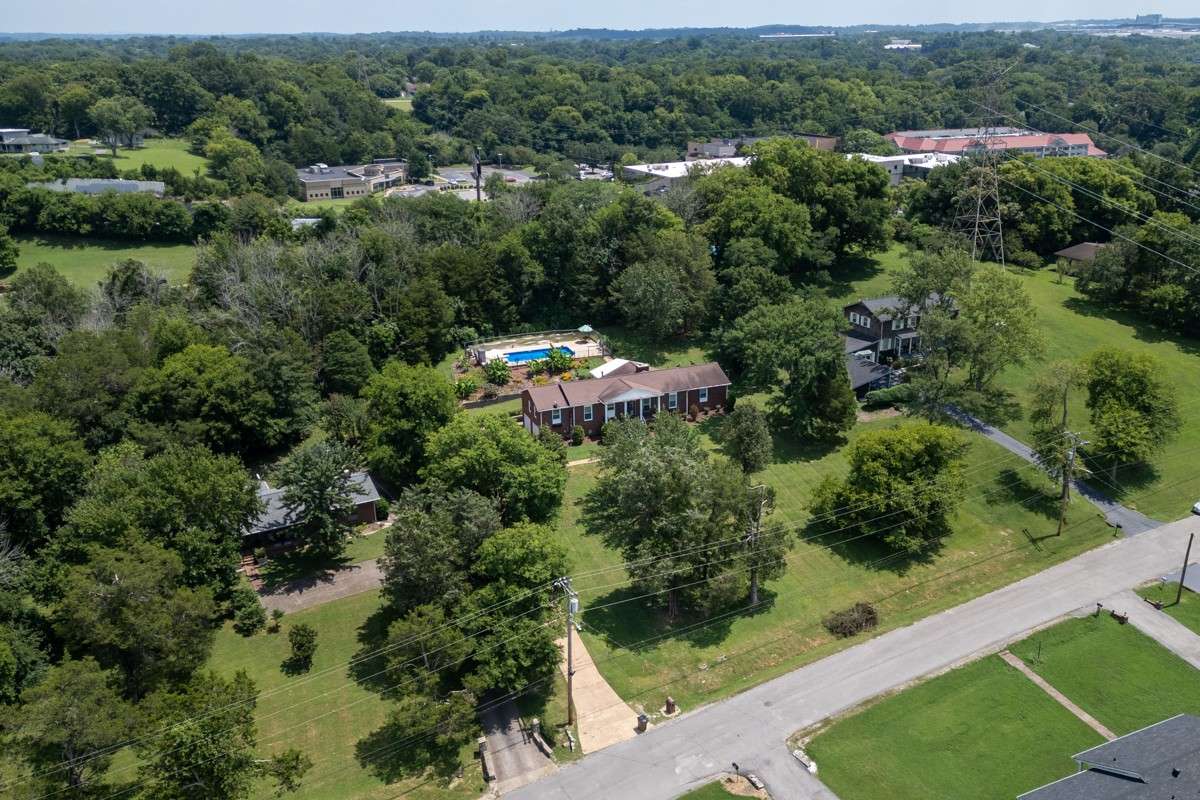 Beautiful brick home on a spacious, private lot with lush landscaping and an inviting backyard pool—perfect for relaxing or entertaining.