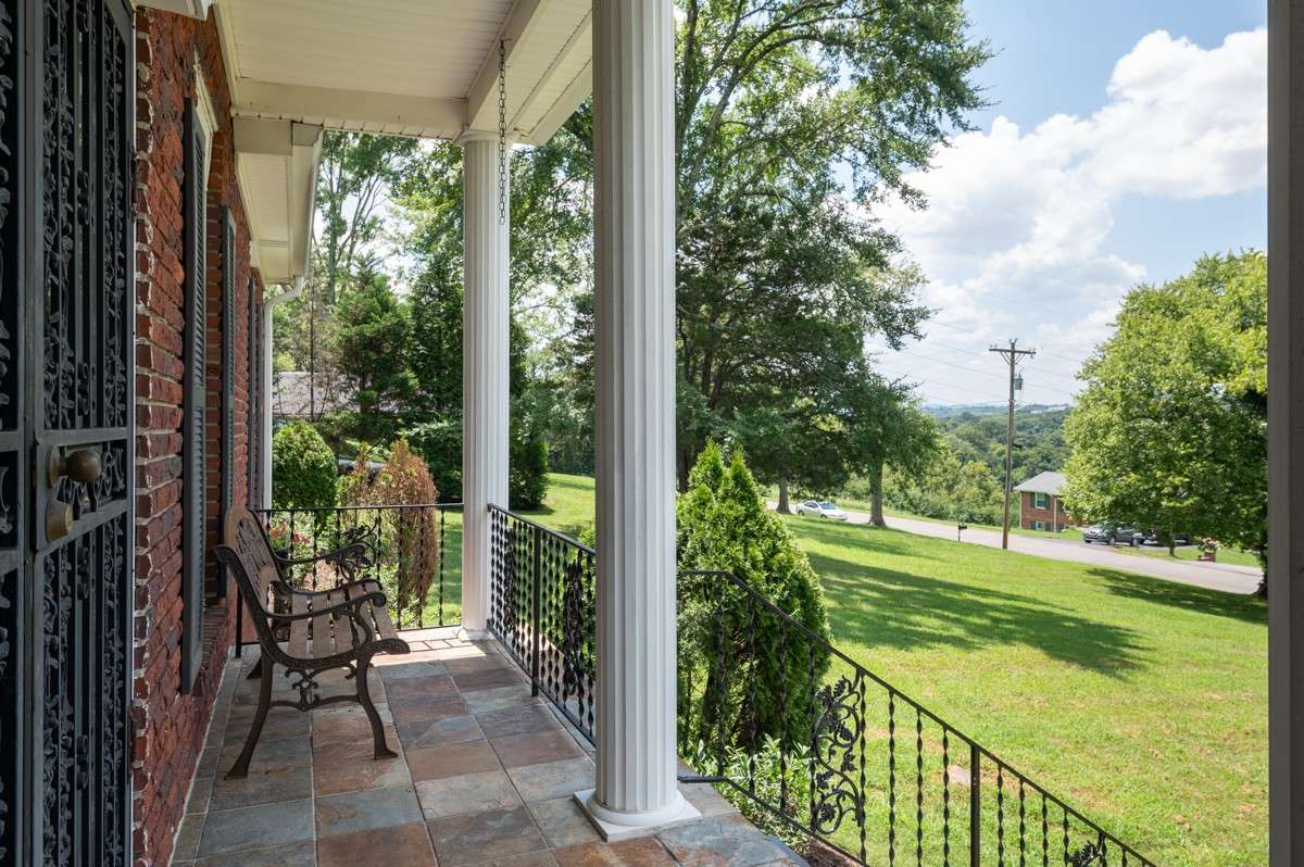 Enjoy peaceful mornings on the front porch with scenic views of the Nashville skyline and lush, mature trees—perfect for relaxing or greeting the day.