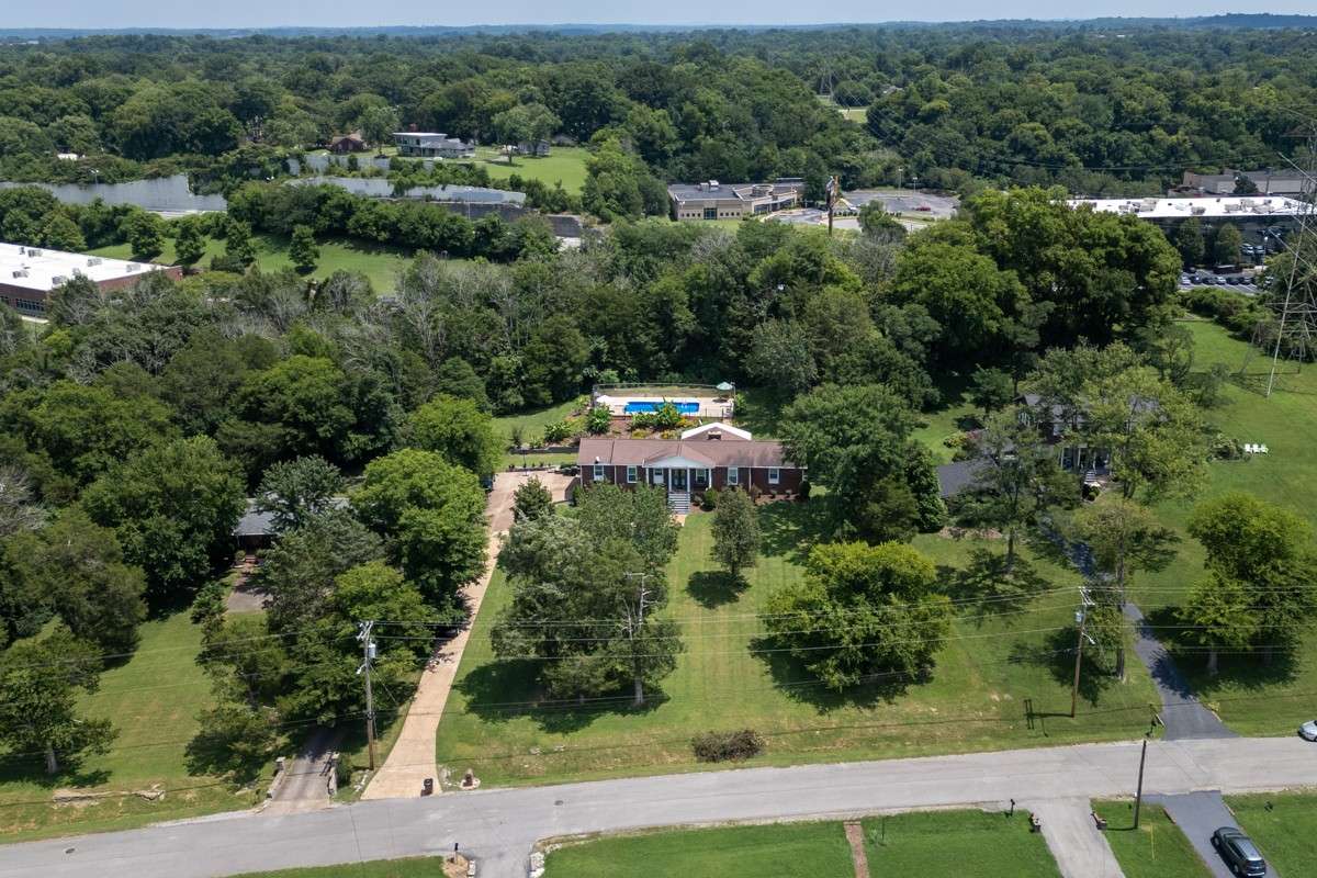 Beautiful brick home on a spacious, private lot with lush landscaping and an inviting backyard pool—perfect for relaxing or entertaining.