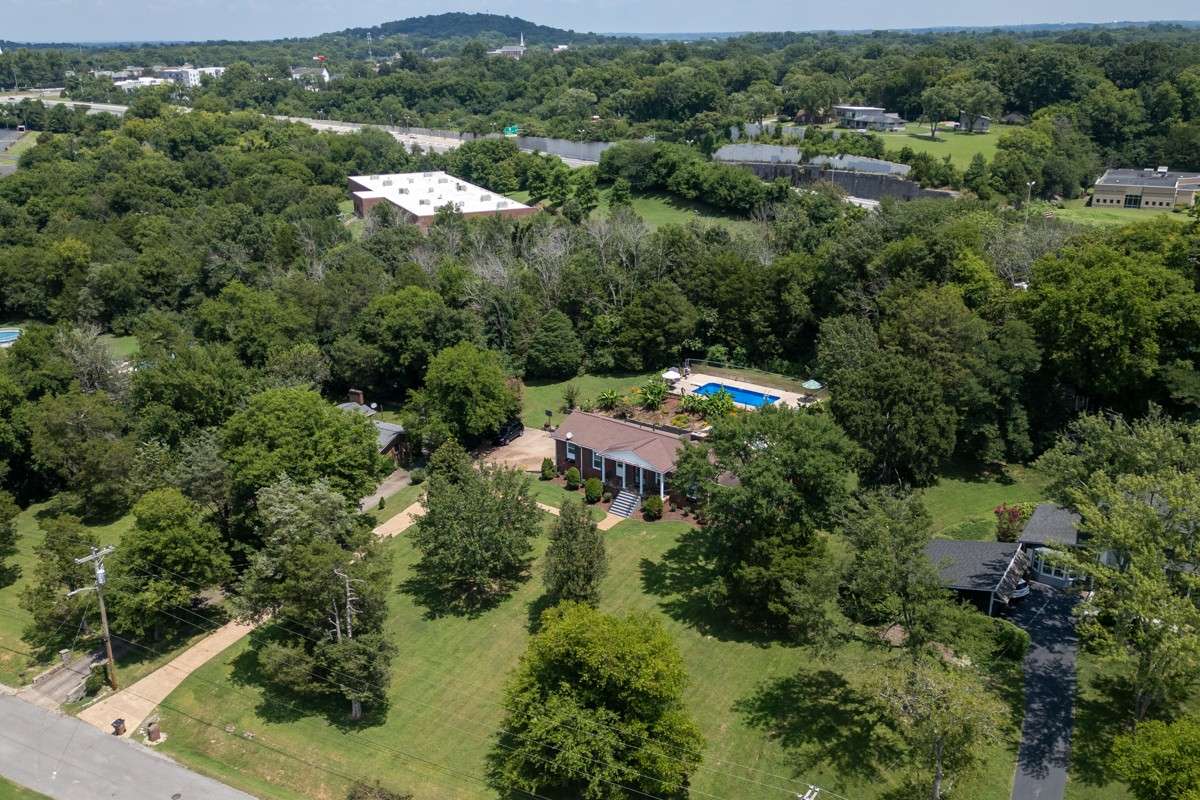 Beautiful brick home on a spacious, private lot with lush landscaping and an inviting backyard pool—perfect for relaxing or entertaining.