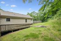 Back of home with access to the screened porch and private backyard.