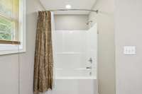 Enjoy the convenience of a tub shower combo in the private primary bath.