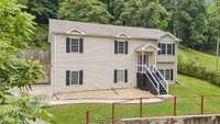 Front view of home with established rock landscaping ready for your personal touch with outdoor shrubs or greenery.