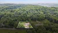 Drone view clearly outlining the property lines and spacious lot.