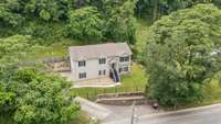 Drone perspective highlighting the home’s lot and neighborhood setting.