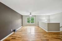 Spacious living room featuring warm hardwood floors and plenty of natural light.