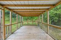 Screened, covered deck providing a comfortable outdoor living space.
